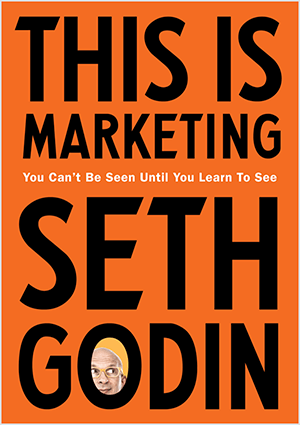 Ceci est une capture d'écran de la couverture de This Is Marketing de Seth Godin. La couverture est un rectangle vertical avec un fond orange et un texte noir. Une photo de la tête de Seth apparaît dans le O de son nom de famille.
